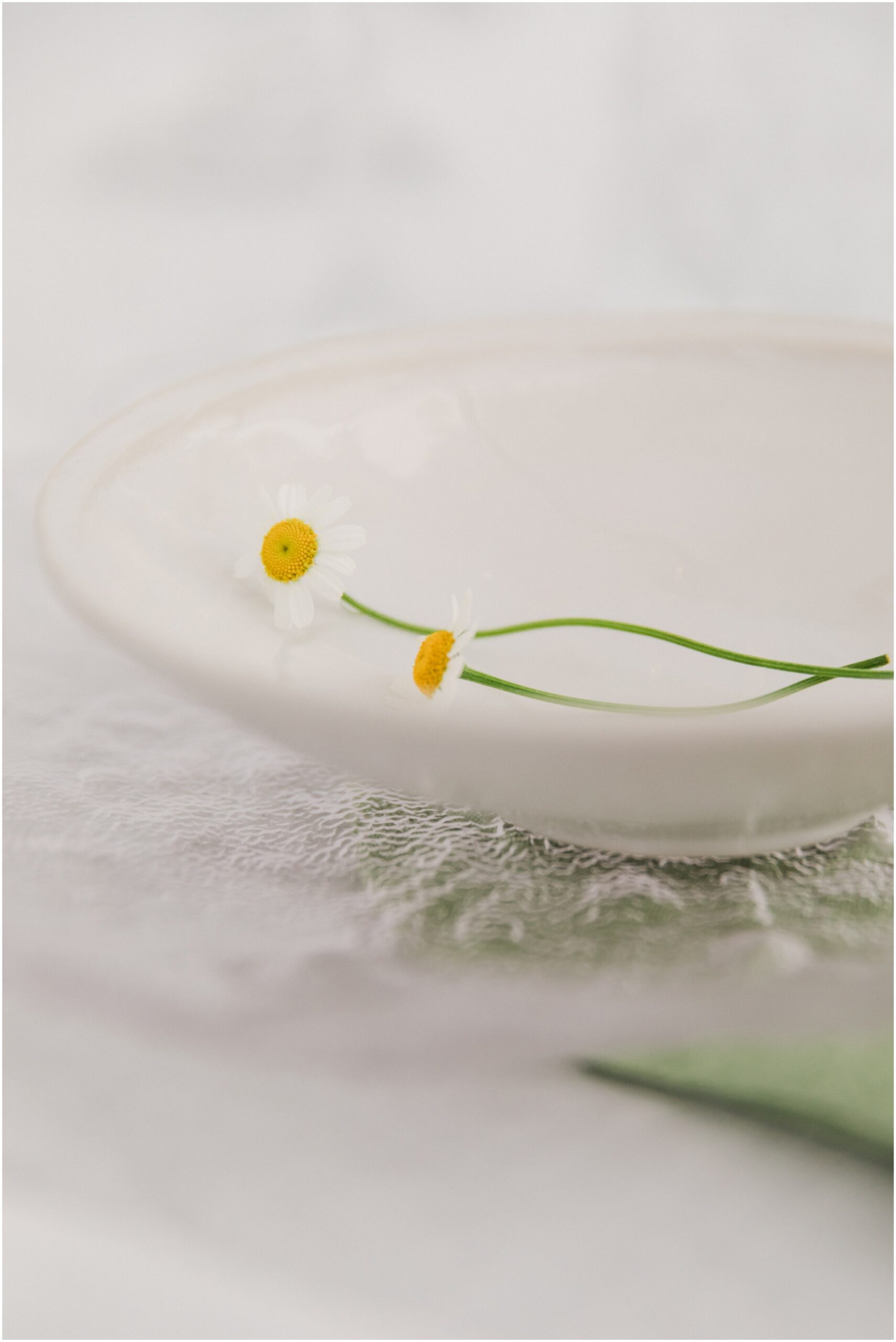 Elegant garden wedding table with white linen and wild floral arrangements at Omahanui